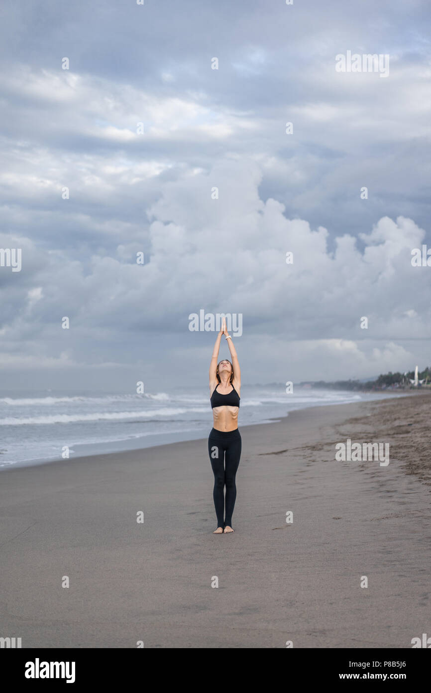 beautiful young woman practicing yoga in Mountain pose (Tadasana) on ...