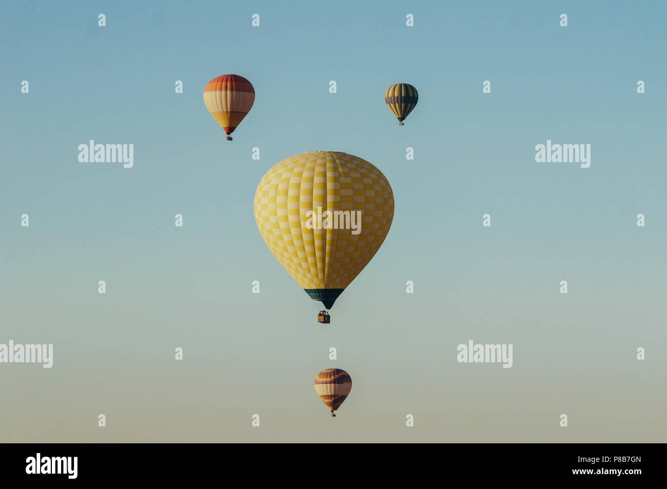 Hot air balloons flying in blue sky Stock Photo - Alamy