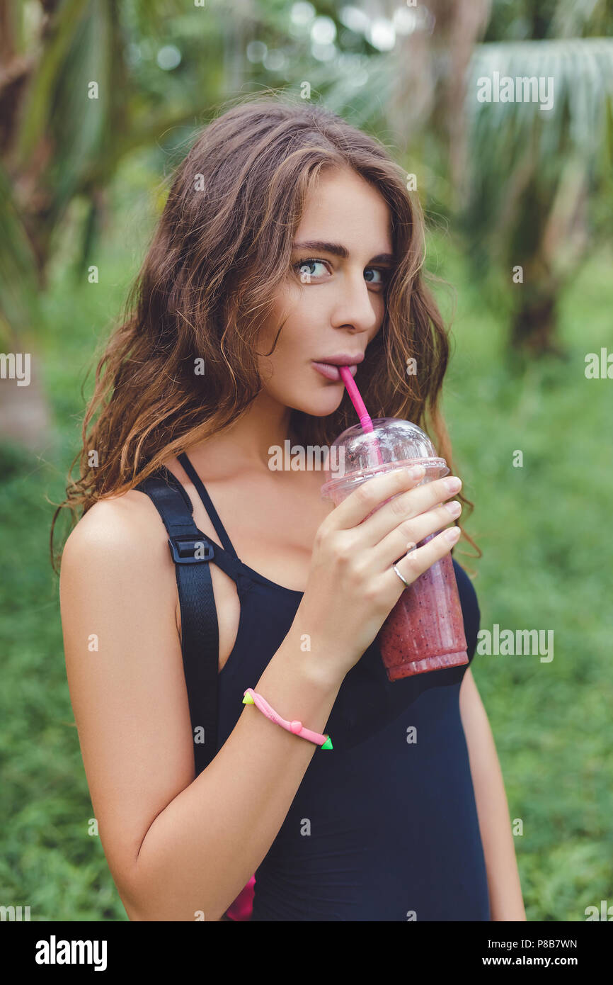 beautiful girl posing in swimsuit drinking smoothie Stock Photo