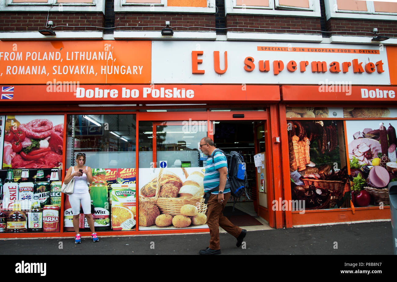 Bognor Regis, Sussex. A man walks past the Polish EU supermarket Stock