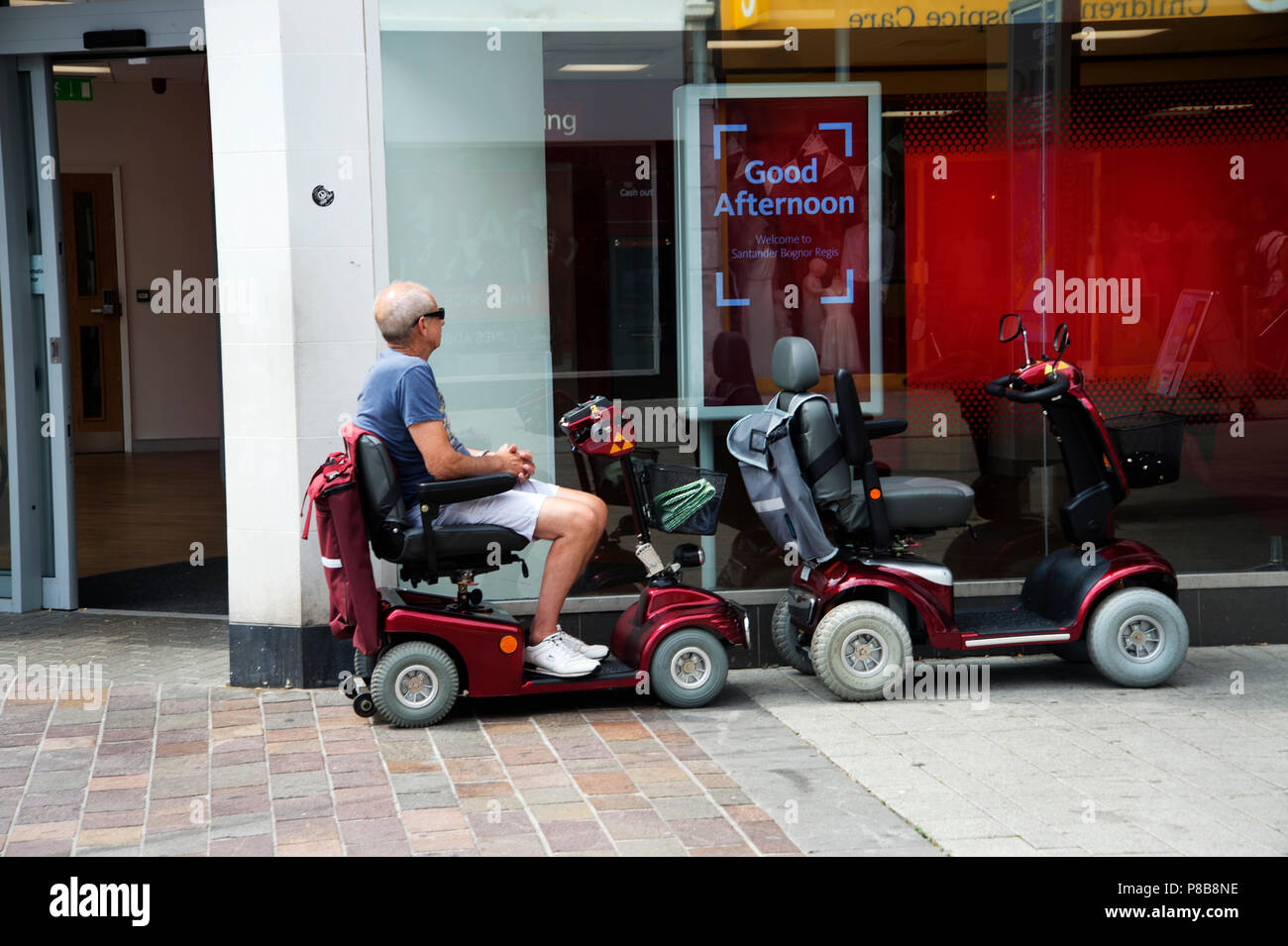 Disability scooter parked outside hires stock photography and images