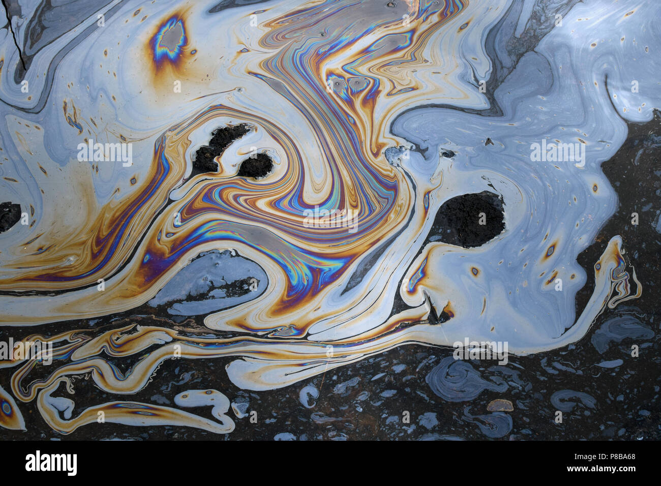 Abstract fluid shapes iridescent colors background. Tar water surface asphalt pit. Stock Photo
