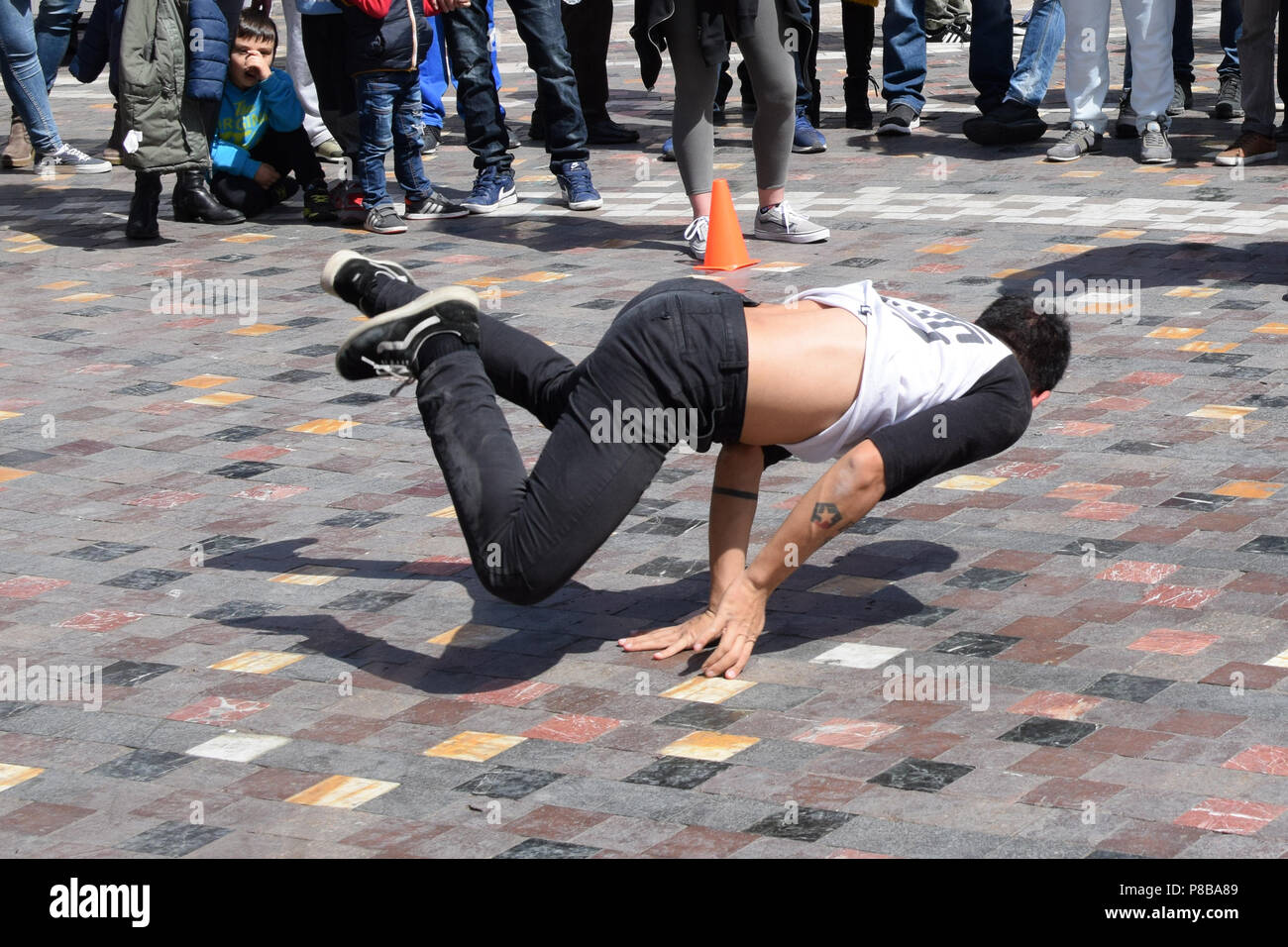 ATHENS, GREECE - APRIL 1, 2018: Young man breakdancing in public square. Urban street dance youth culture. Stock Photo