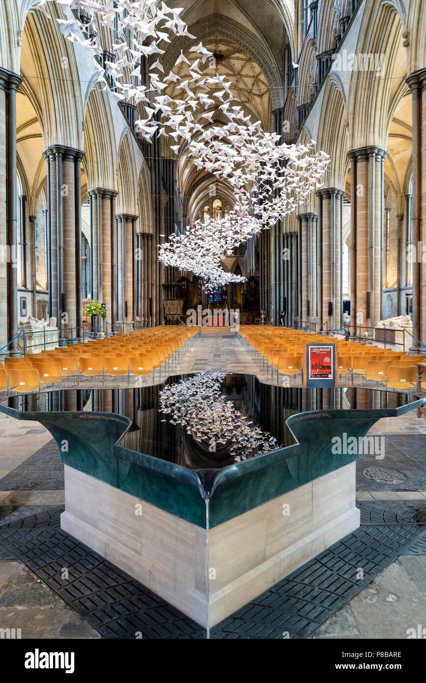 Salisbury Cathedral font and Les Colombes art installation Stock Photo