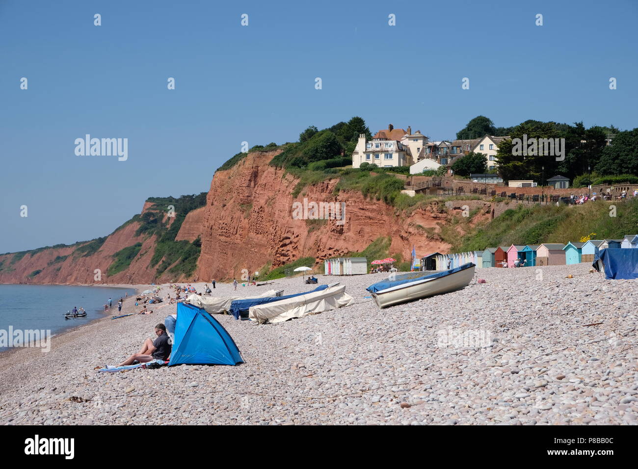 The sea front at Budleigh Salterton, South Devon, England, looking west. The red cliffs visible are of Triassic age, also known as the Jurassic Coast Stock Photo