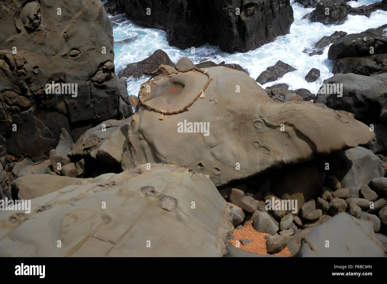 Red Rope Around Rocks Japan Rope and Rock at the Udo Jingu - Shinto Shrine located in Miyazaki ...