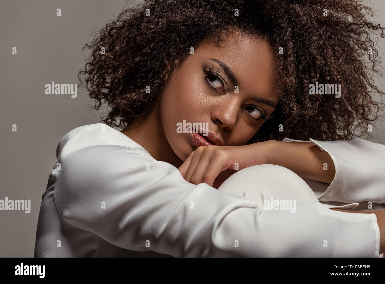 Young sensual african american woman in white shirt looking away ...