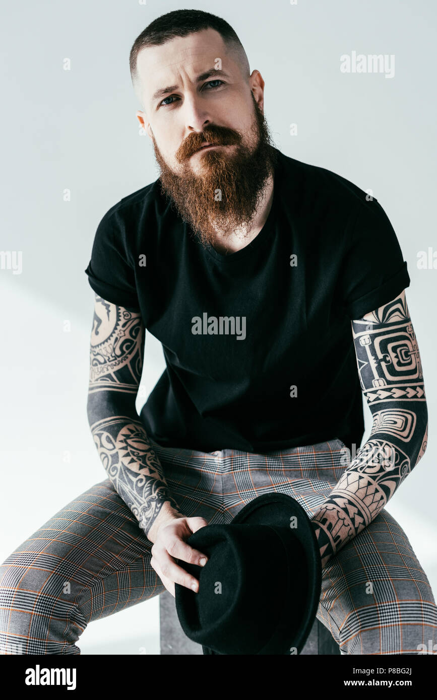 handsome bearded tattooed man looking at camera on white Stock Photo - Alamy