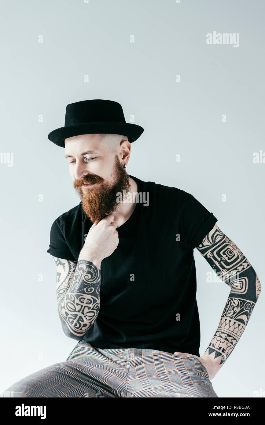 handsome tattooed man touching beard isolated on white Stock Photo - Alamy