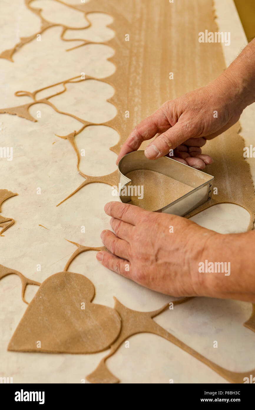 cutting biscuits at Christmas Stock Photo