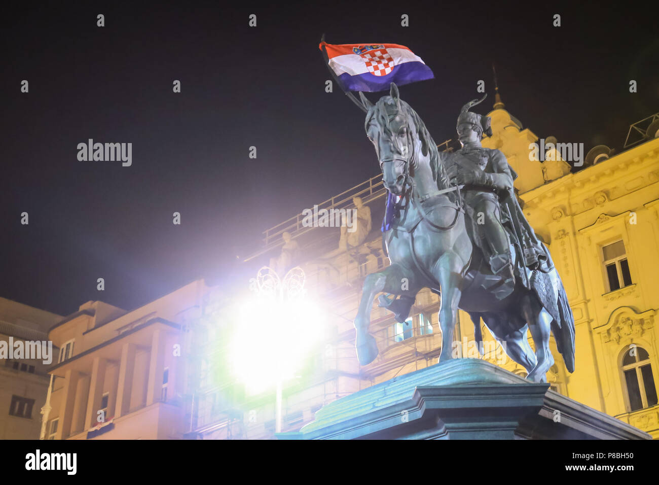 ZAGREB, CROATIA - JULY 7TH, 2018 : Croatian football fans flagged the Croatian flag on the statue of Ban Josip Jelacic after win of Croatian national  Stock Photo