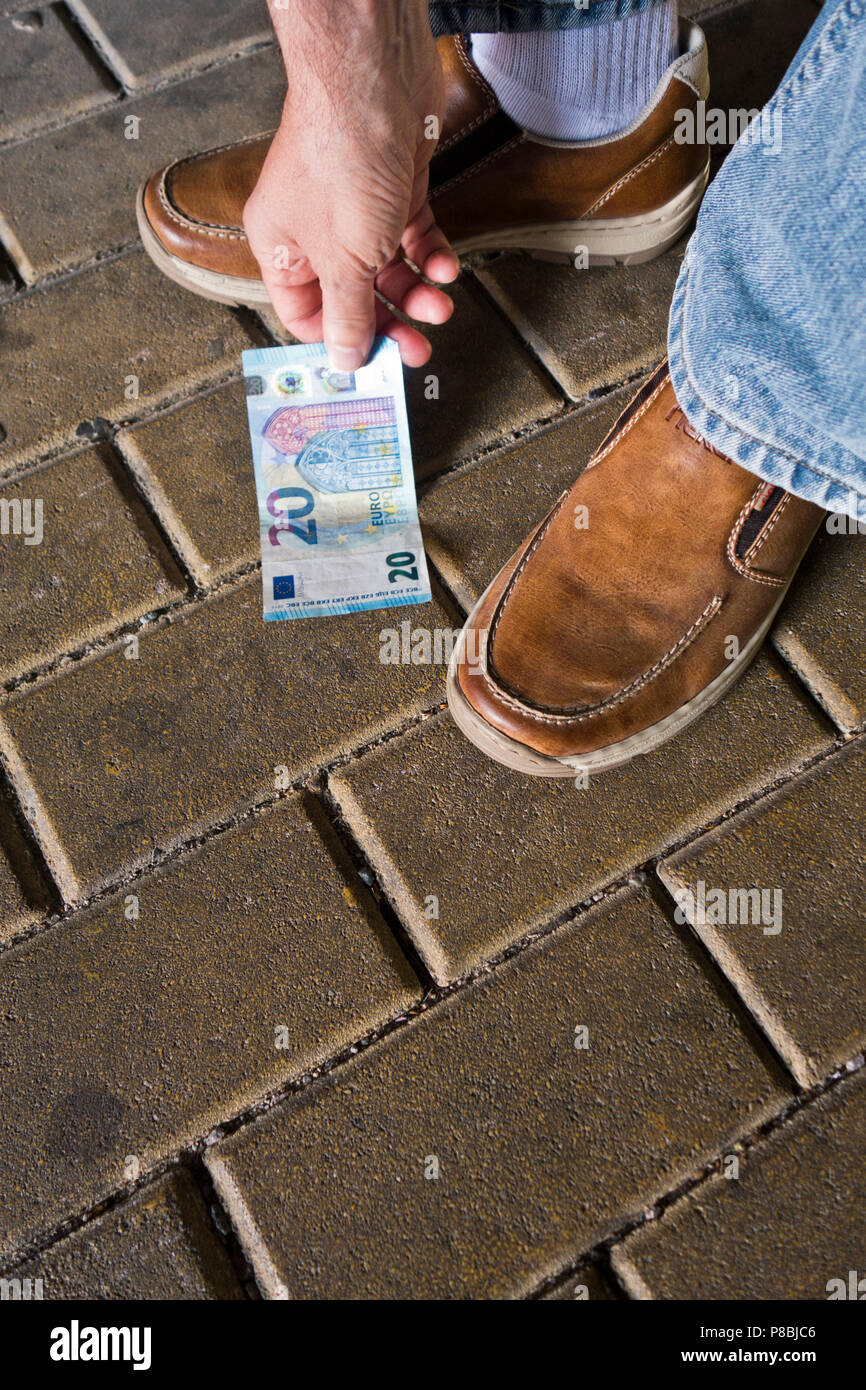 finding a banknote on the street Stock Photo