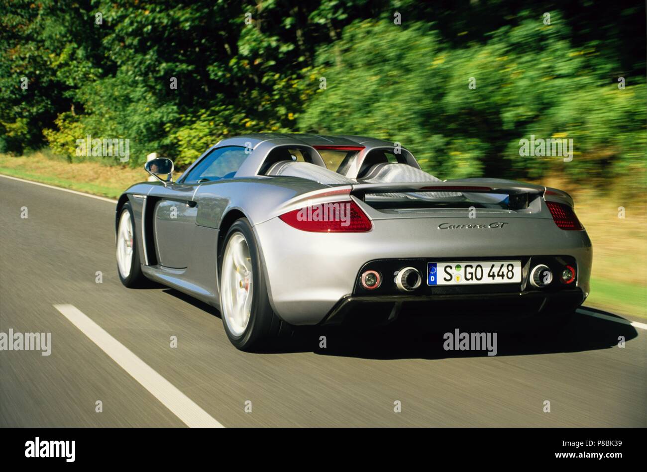Porsche Carrera GT 2005 model in silver - rare hyper car showing rear view  as driving in motion Stock Photo - Alamy