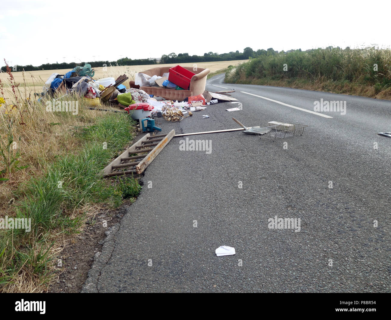 Lorry tipped rubbish all over the road by back off loading household rubbish into a lane in this picturesque part Dinnington, South Yorkshire Stock Photo