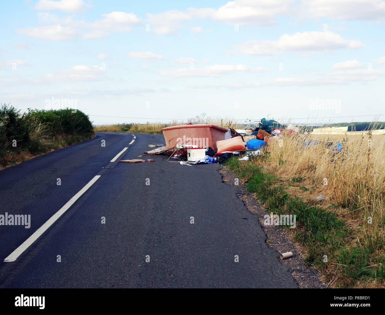 Lorry tipped rubbish all over the road by back off loading household rubbish into a lane in this picturesque part Dinnington, South Yorkshire Stock Photo