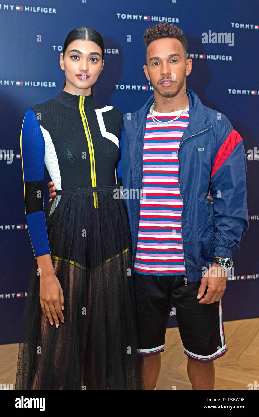Lewis Hamilton with model Neelam Gill at the Tommy Hilfiger store on Regent London ahead of 'An audience with Lewis Hamilton' - Alamy
