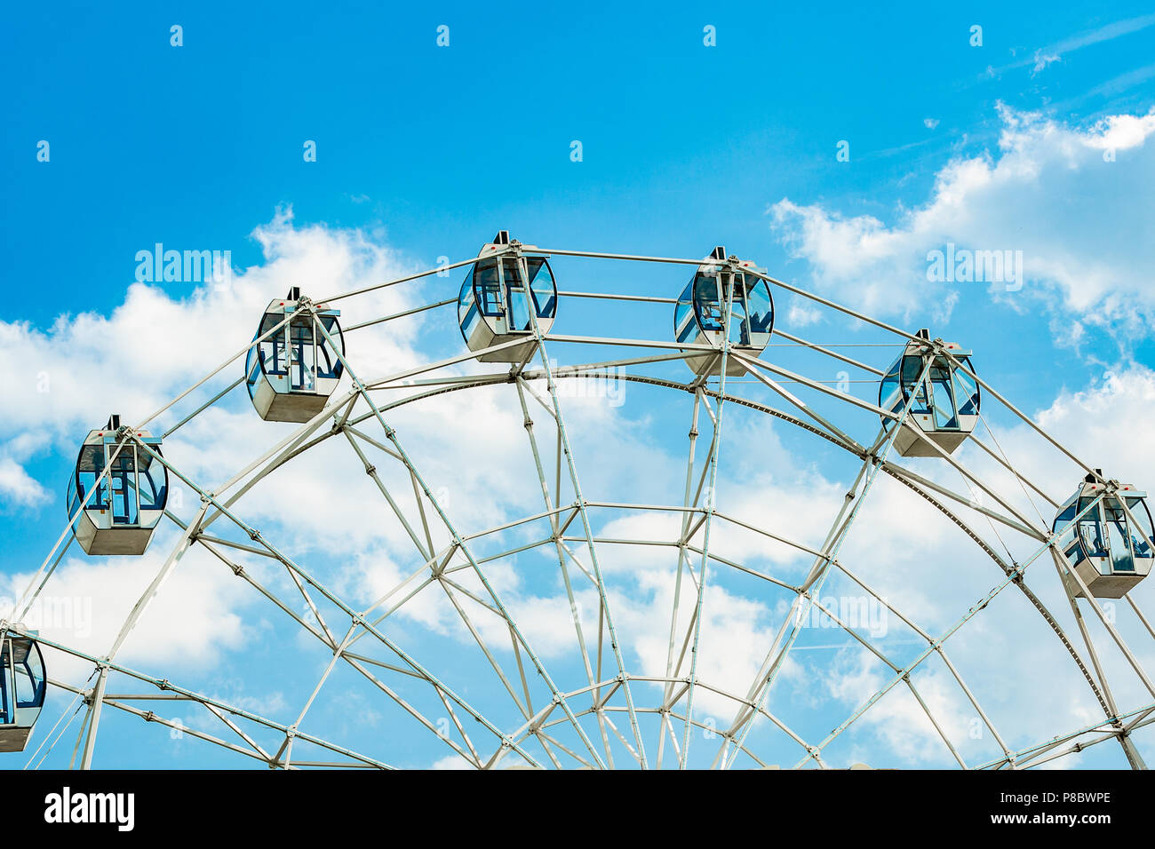 Ferris wheel on cloudy sky background Stock Photo - Alamy