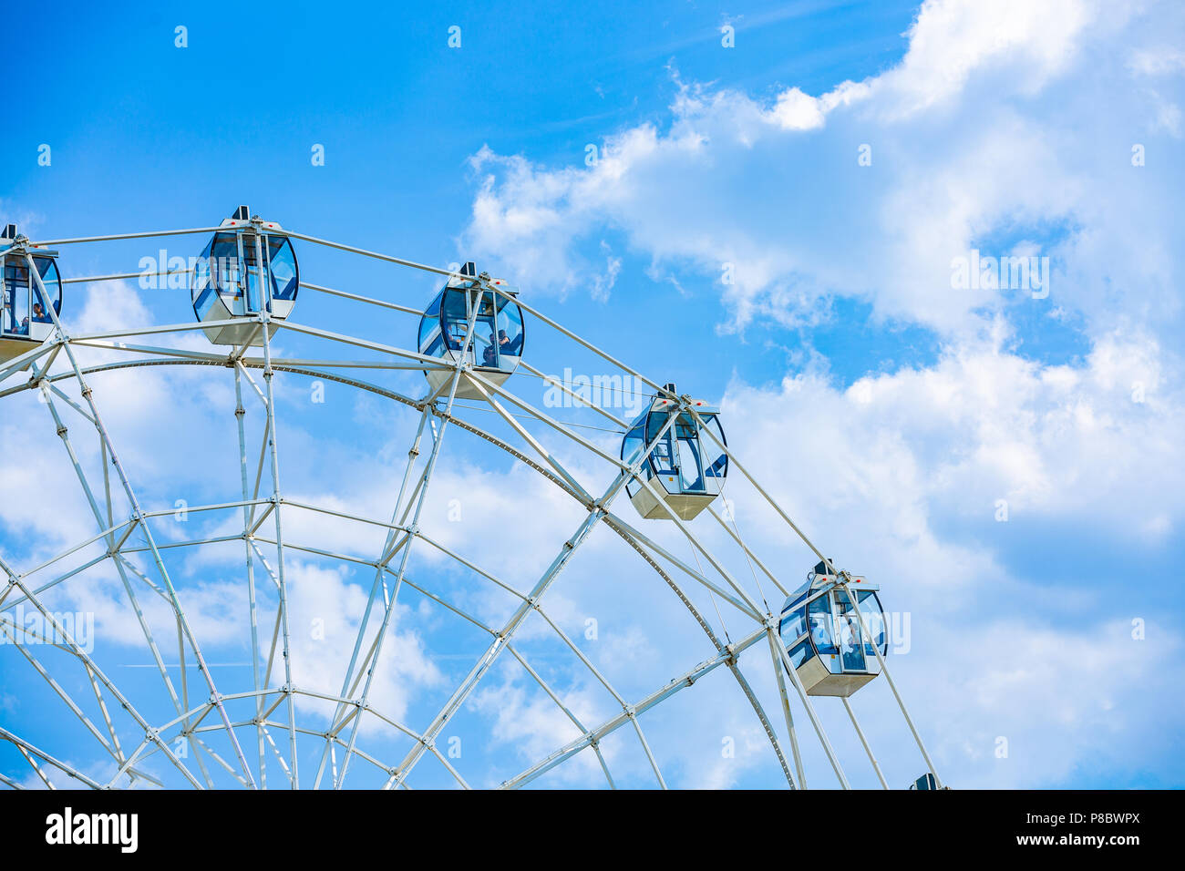 Ferris wheel on cloudy sky background Stock Photo - Alamy