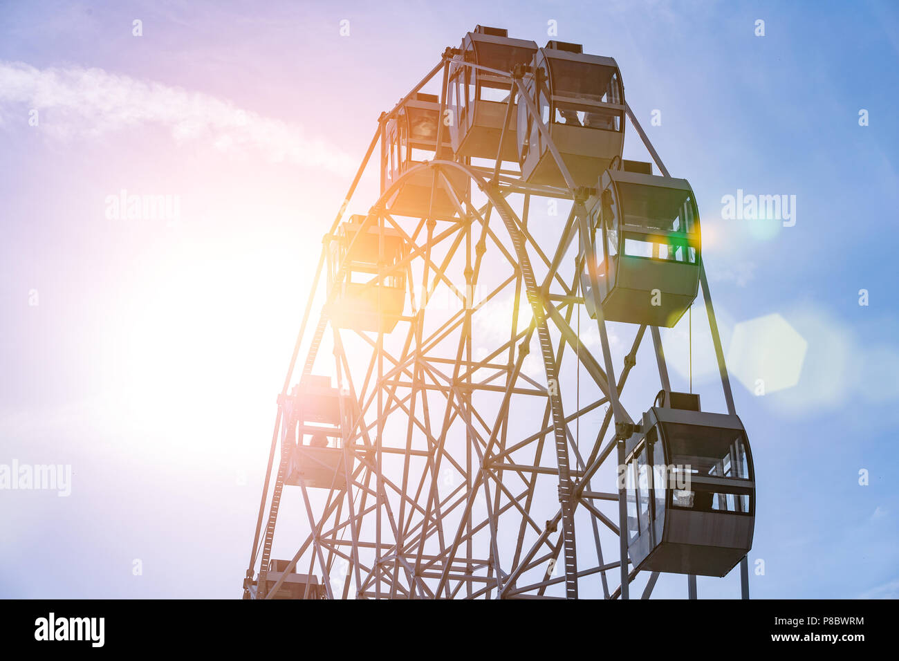 Ferris wheel on cloudy sky background Stock Photo - Alamy