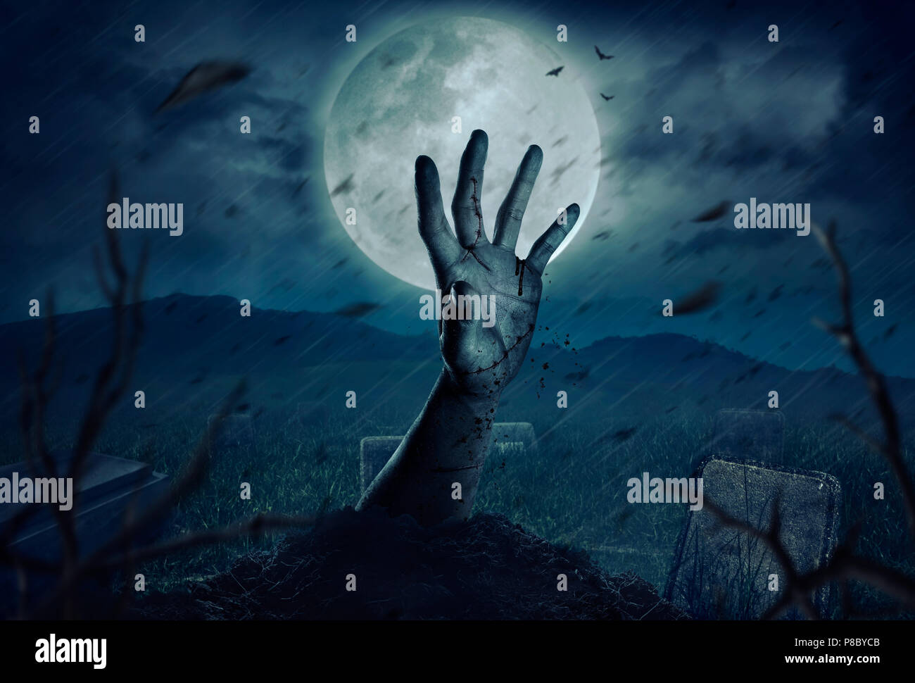 Zombie hands rising in dark Halloween night. Stock Photo