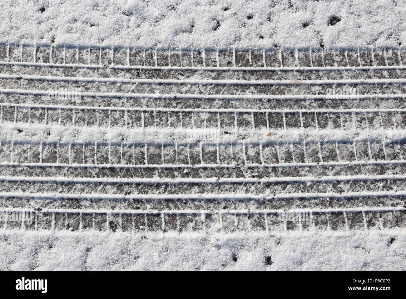 Snow tyre tracks - snowy winter road surface background Stock Photo - Alamy