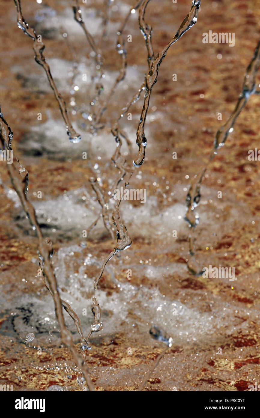 Berlin, Germany, running water plaetschert on the bottom of a fountain Stock Photo