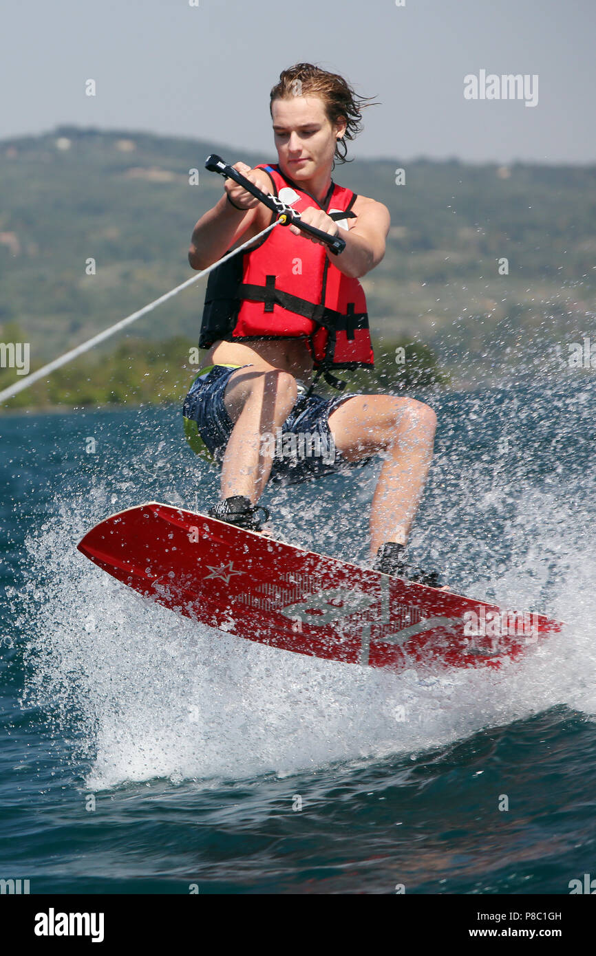 Capodimonte, Italy, boy is water skiing on Lake Bolsena Stock Photo