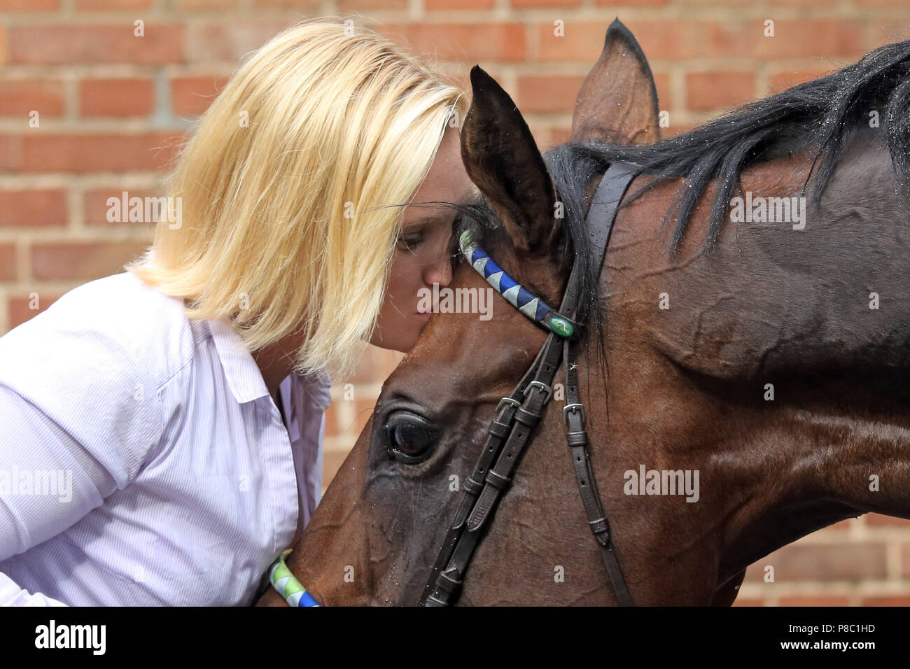 Hoppegarten, woman kisses her horse on the forehead Stock Photo