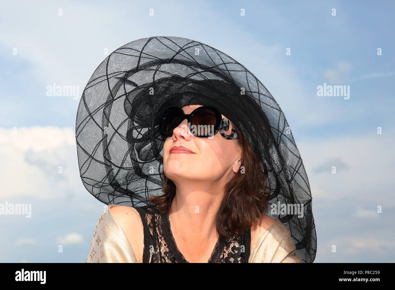 Iffezheim, Fashion, elegantly dressed woman with hat on the racecourse Stock Photo