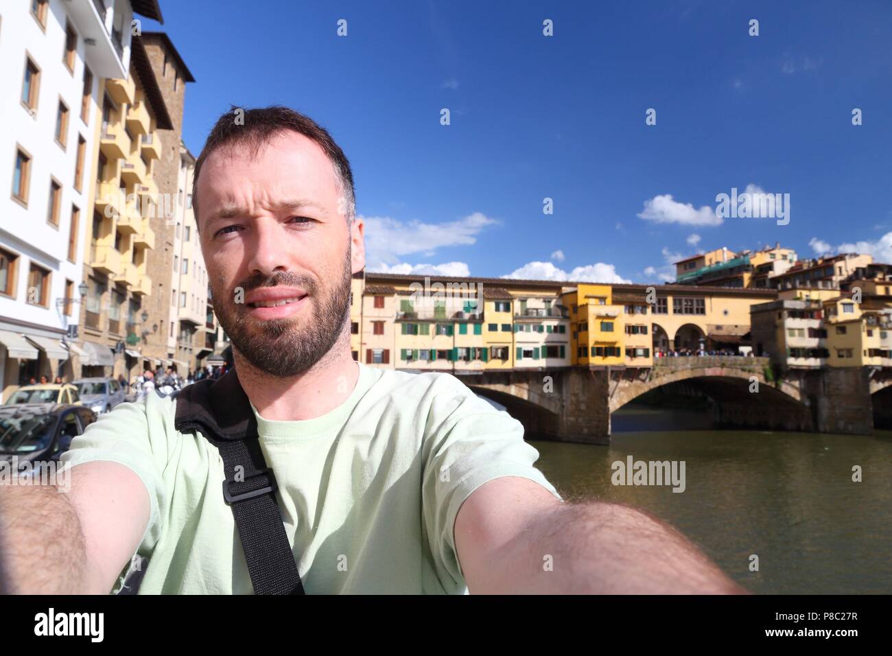 Florence - Vecchio Bridge. Male traveler - European vacation selfie. Stock Photo