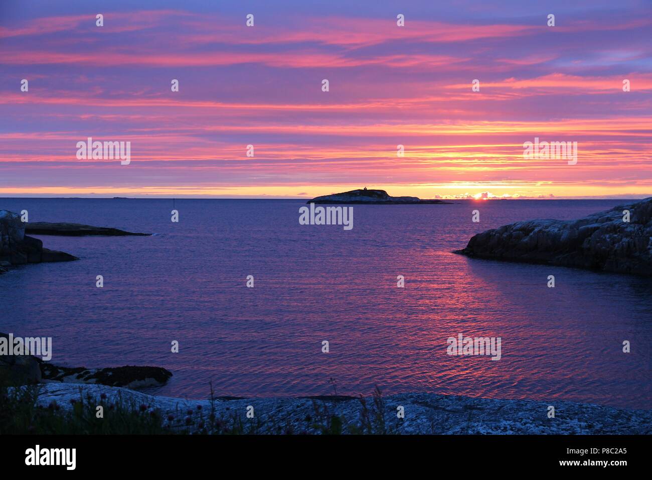 Sunset sky in Norway. Coast off Averoya island (More og Romsdal region). Stock Photo