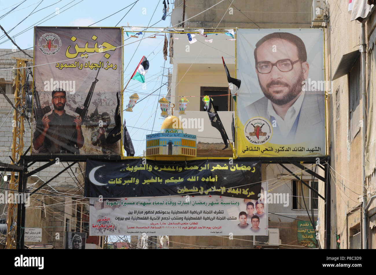 Lebanon:  Political and religios paroles on posters in the palestinian refugie camp Schatila in Beirut. Stock Photo