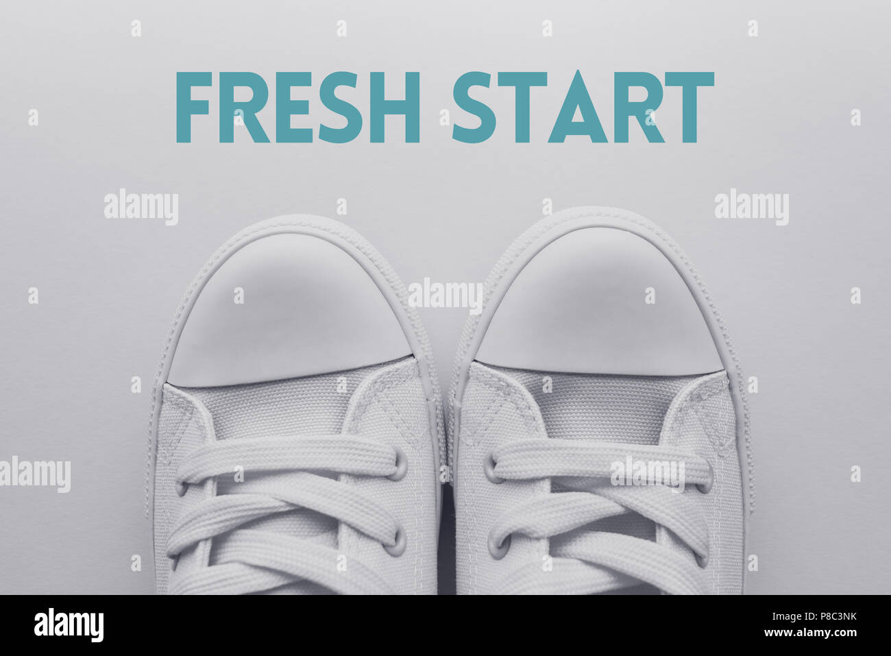 Fresh start and new beginning concept, youth style sneakers standing over title Stock Photo