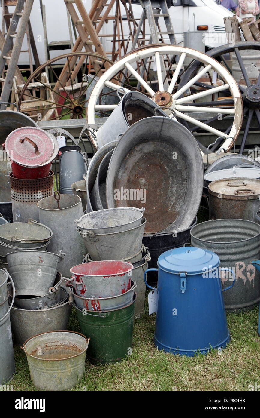 Group of old antique galvanised iron buckets and tin baths on display