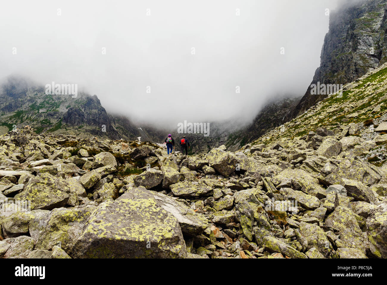 Couple travelers climb to the top mount Rysy, high tatras mountains in Slovakia Stock Photo