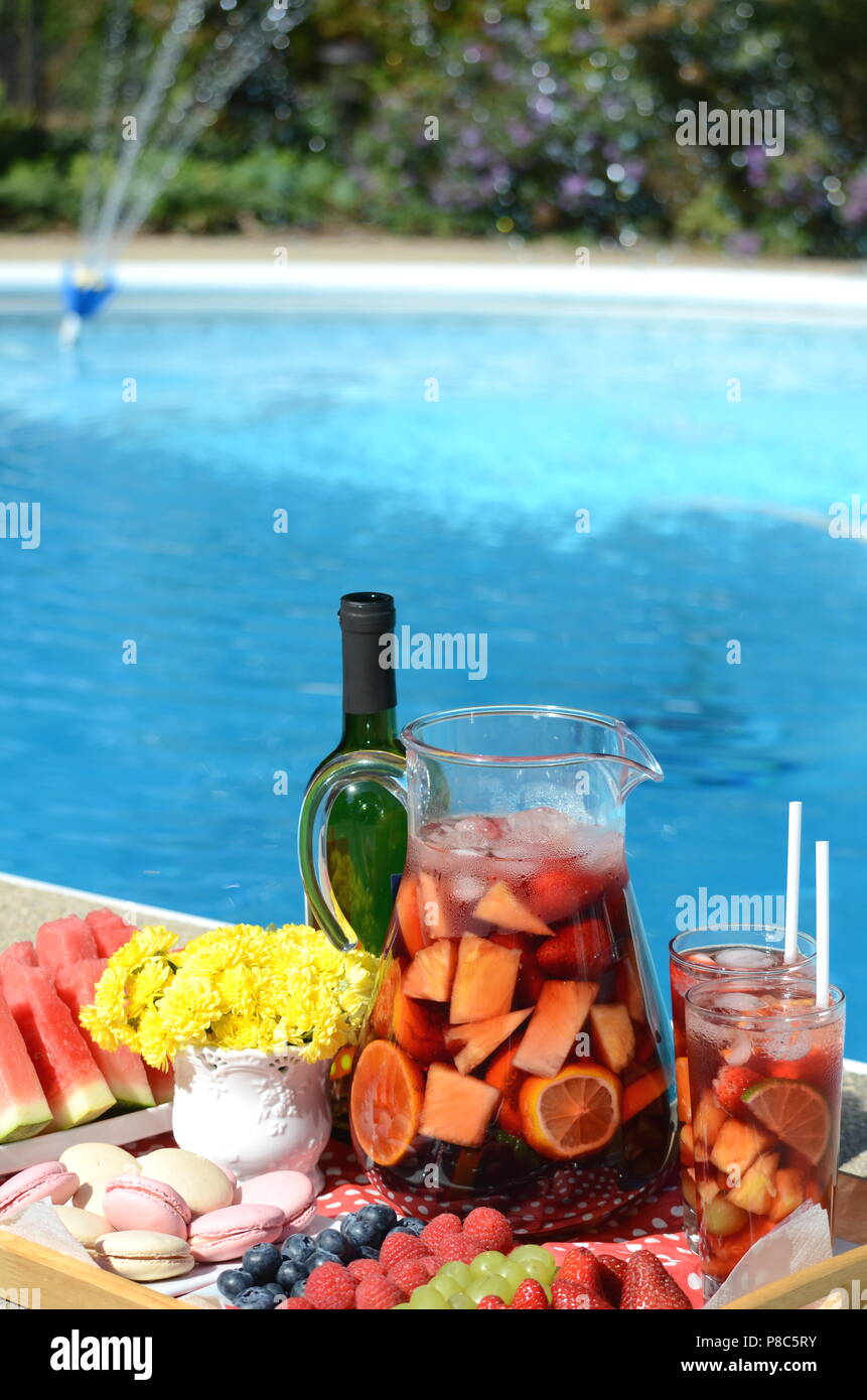 Pool party with sangria pitcher, fruit cocktails and refreshments by the  swimming pool. Summer lifestyle, topical vacation, fun and relaxation theme  Stock Photo - Alamy