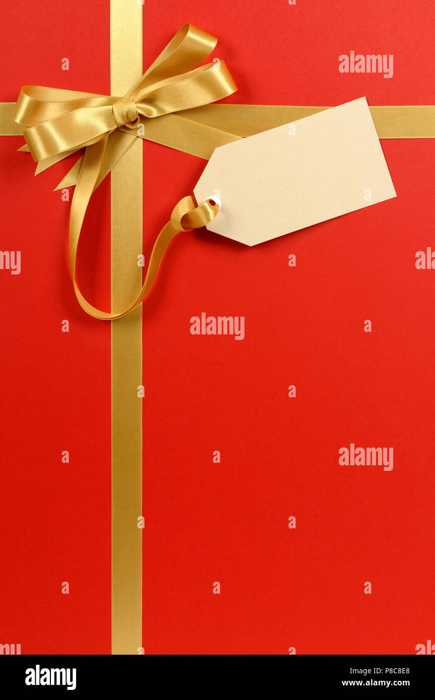 Red gift background, gold ribbon bow, blank gift tag or label, copy ...