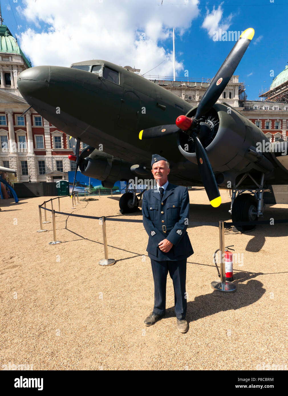 A veteran in period RAF uniform pose beside a  Dakota DC3 on display at Horse Guards Parade, part of the Centennial celebrations of the RAF Stock Photo
