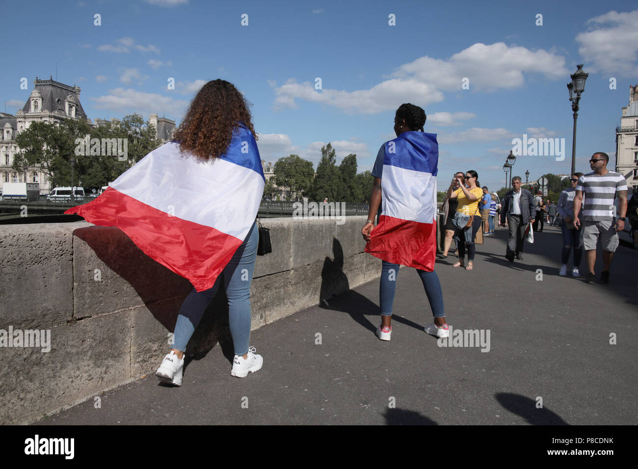 Paris, France. 10th July, 2018. FIFA World Cup 2018, semi-finals: France vs Belgium. Fans with French flags in front of the Paris City Hall on their way to the public viewing. France and Belgium are playing against each other in the first semi-finals match of the 2018 soccer World Cup in St. Petersburg. Credit: Leo Novel/dpa/Alamy Live News Stock Photo