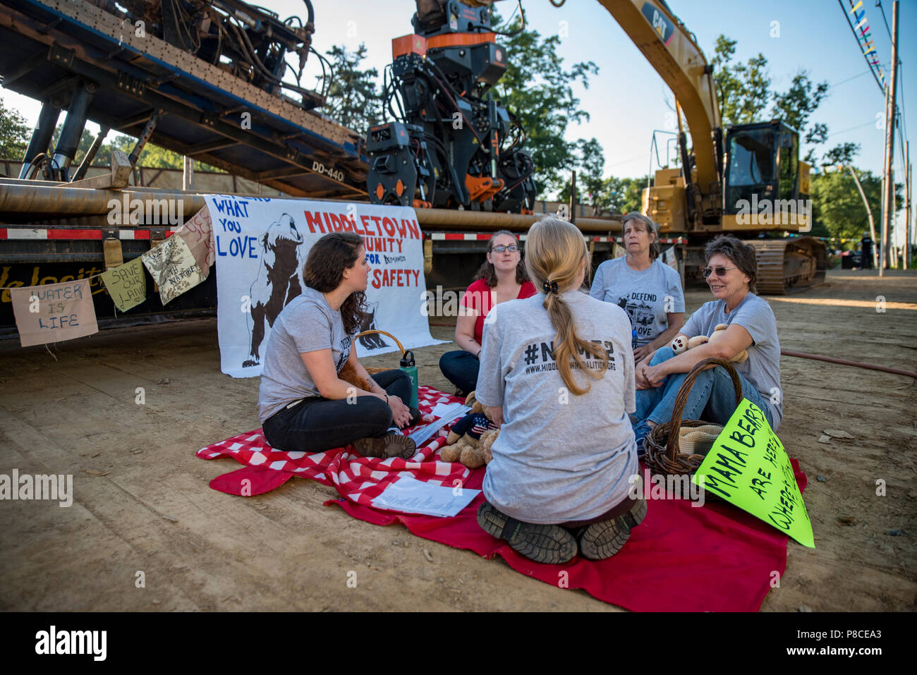 Media, PA / USA. 10th July, 2018. Residents from Middletown Township gathered for a Mama Bear's picnic on Sunoco's Mariner East 2 pipeline construction site halting work for an hour and highlighting growing community opposition to the project. Activists who joined the action raised concerns for their safetey in the blast and evacuation zones for homes and schools along the pipeline route. Credit: Christopher Evens/Alamy Live News Stock Photo