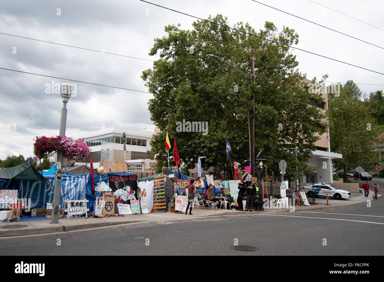 Portland, USA. 10th July, 2018. Protesters in front of their camp next to the Portland ICE (U.S. Immigration and Customs Enforcement) building Credit: David Krug/Alamy Live News Stock Photo