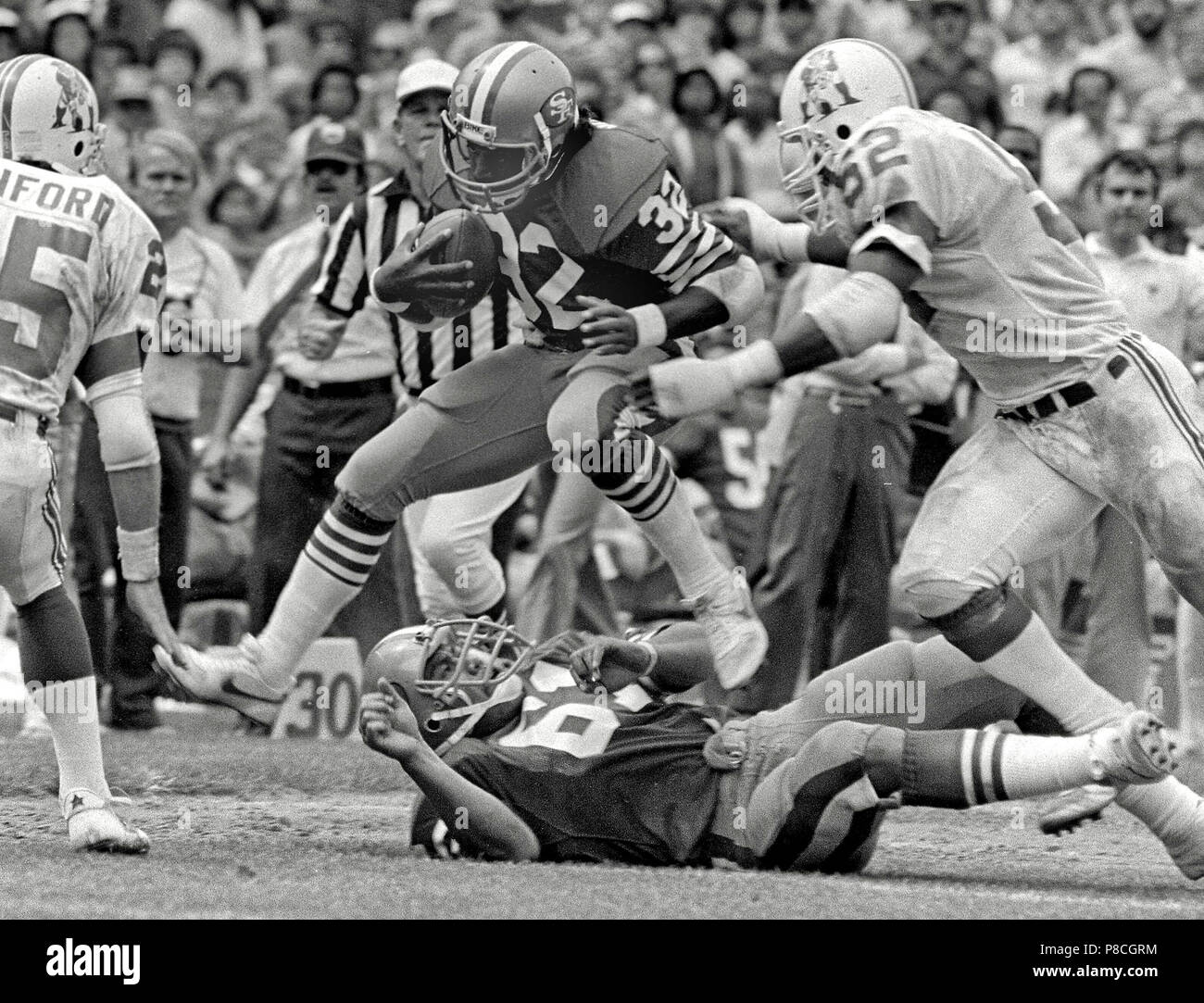 San Francisco, California, USA. 14th Aug, 1983. San Francisco 49ers vs. New England Patriots at Candlestick Park Sunday, August 14, 1983. Pre-season Game. San Francisco 49ers Running Back Carl Monroe (32) with New England Patriots Linebacker Johnny Rembert (52) about to tackle. Credit: Al Golub/ZUMA Wire/Alamy Live News Stock Photo