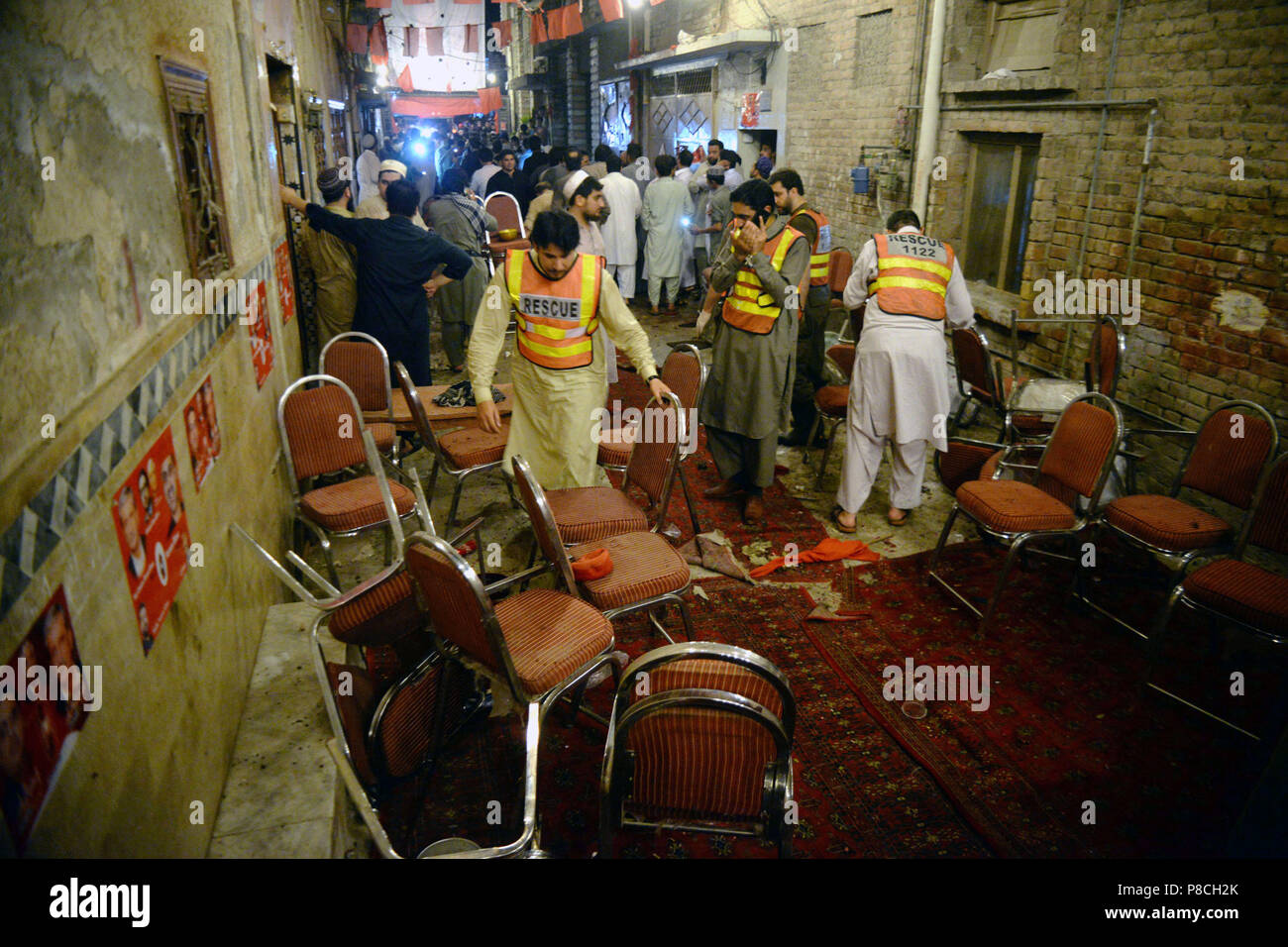 Peshawar, Pakistan. 10th July, 2018. Rescuers work at the blast site in Peshawar, northwest Pakistan, on July 10, 2018. At least 13 people were killed and dozens of others injured in a blast that hit a public gathering of a political party in Pakistan's northwest provincial capital of Peshawar on Tuesday night, local media reported. Credit: Umar Qayyum/Xinhua/Alamy Live News Stock Photo