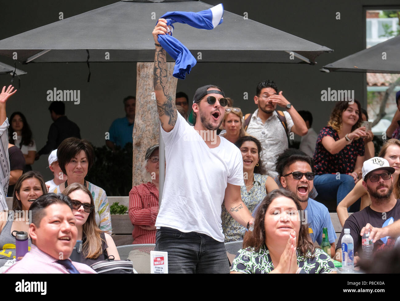Los Angeles, USA. 10th July, 2018. Soccer fans celebrate after France defeating Belgium during a 2018 FIFA World Cup semifinal viewing party at the Hammer Museum in Los Angeles, the United States on July 10, 2018. France won 1-0. Credit: Zhao Hanrong/Xinhua/Alamy Live News Stock Photo