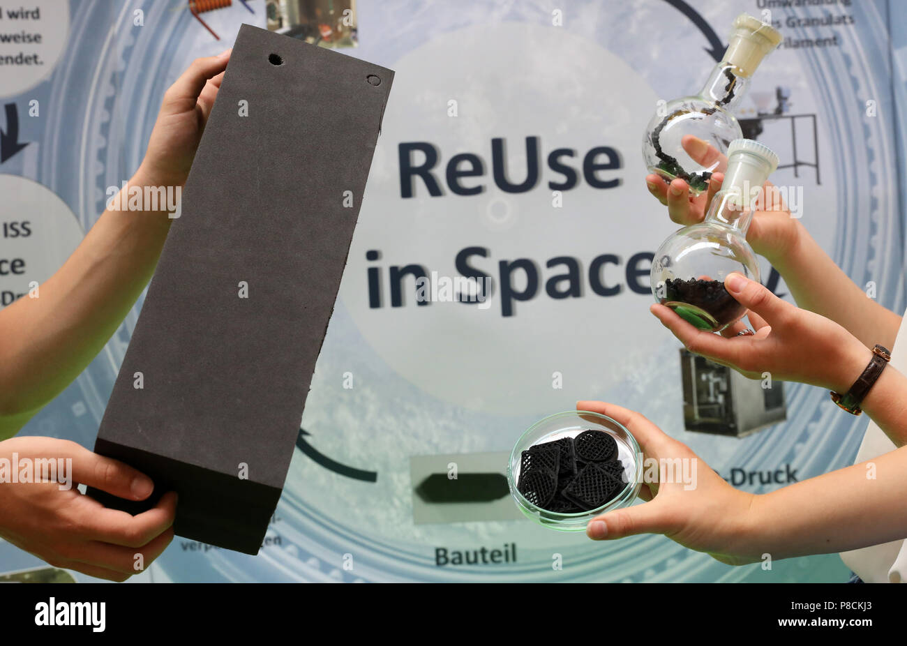 Rostock, Germany. 10th July, 2018. The high school students demonstrating their project 'ReUse in Space' in which plastic is recycled on the International Space Station (ISS). In the process, a 3D printer can be created with the accumulated plastic waste aboard the ISS. The 18-year-olds have won the 'Jugend Forscht' competition with this idea and are now presenting their project to representatives of the airbus space sector. Credit: Bernd Wüstneck/dpa/Alamy Live News Stock Photo