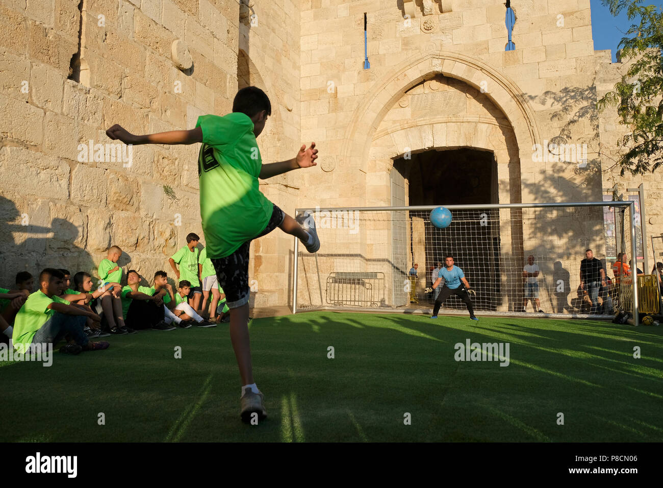 Israel, Jerusalem 10th July 2018. Members of local Jewish and Arab youth soccer teams taking part in a coexistence event of penalty shoot-out during World Cup in Jaffa gate old city Jerusalem Israel. The event is organized by Kulna, a non-governmental organisation which has been holding Jewish-Arab tournaments in Jerusalem for the past year, to advance coexistence between the city’s embattled populations. Credit: Eddie Gerald/Alamy Live News Stock Photo