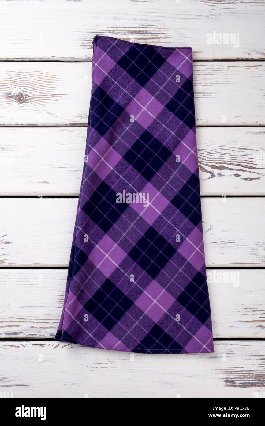 Folded woolen purple checkered skirt. Stock Photo