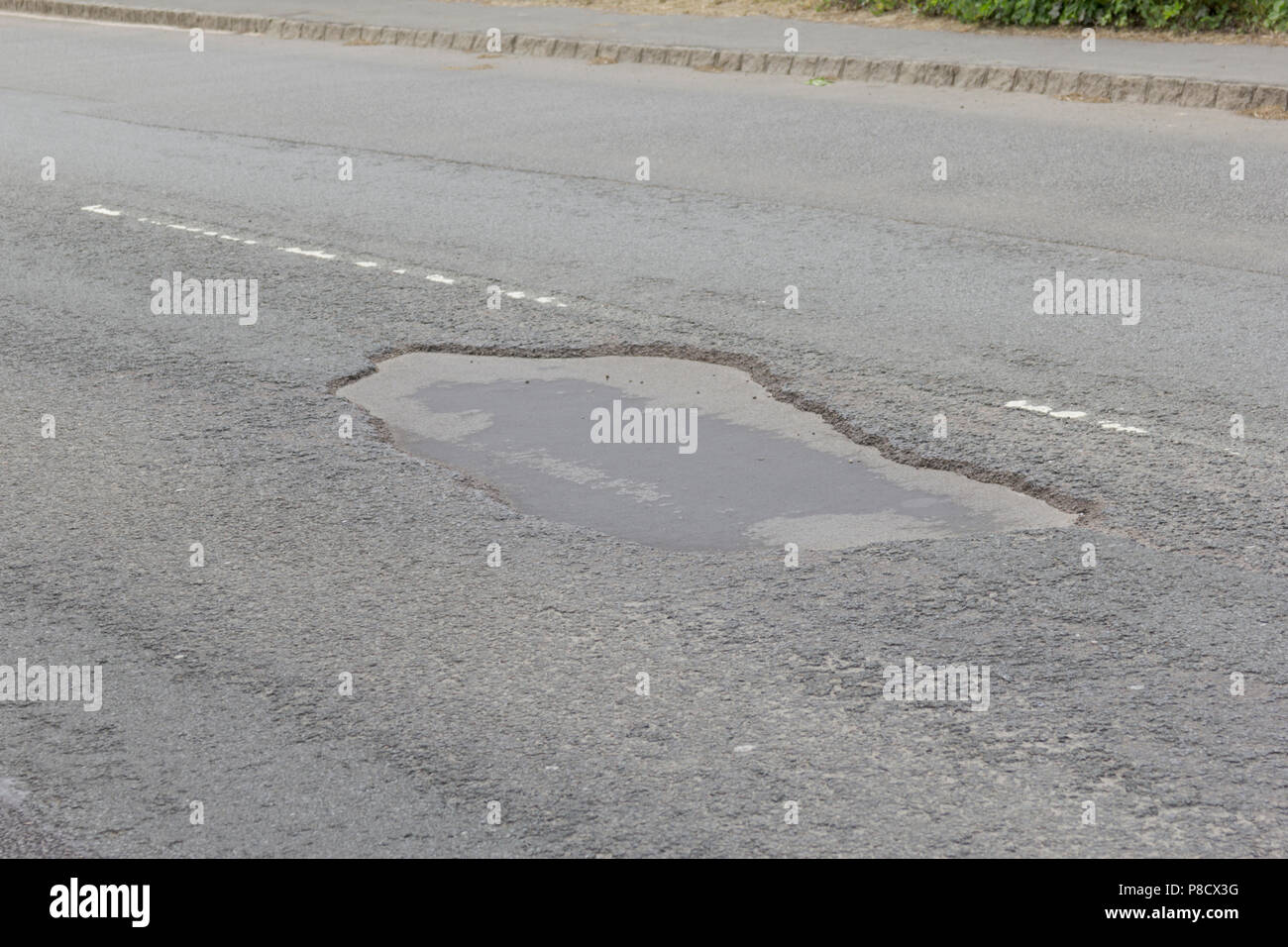 Pot holes in Carterton, Oxfordshire UK. 13th May 2018. UK Weather: Pot holes in West Oxfordshire, multiple potholes on the streets of Oxfordshire. Stock Photo
