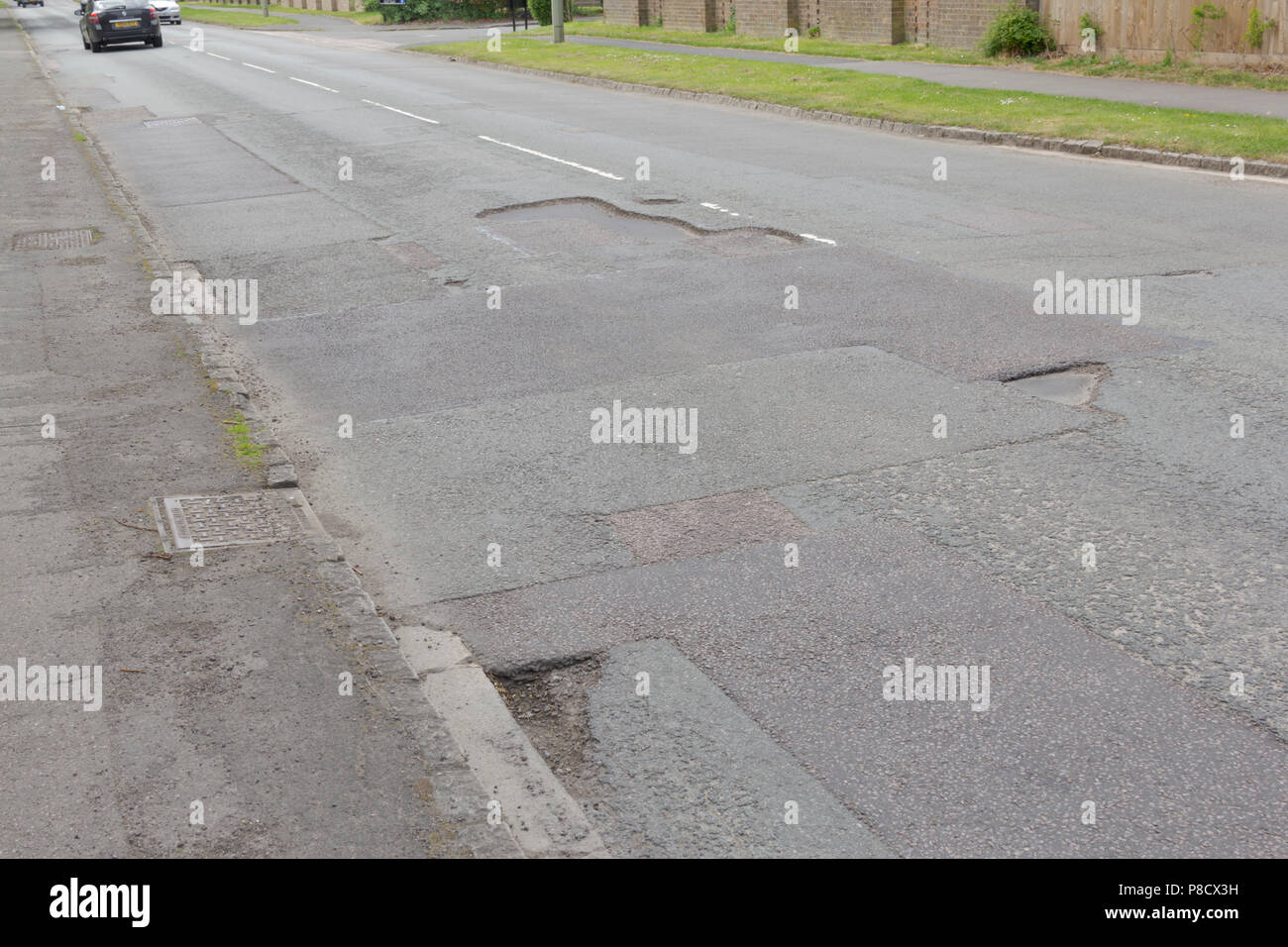 Pot holes in Carterton, Oxfordshire UK. 13th May 2018. UK Weather Pot