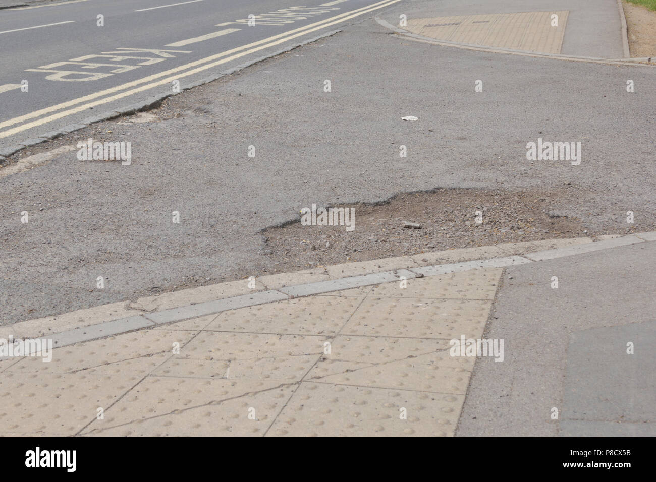 Pot holes in Carterton, Oxfordshire UK. 13th May 2018. UK Weather Pot